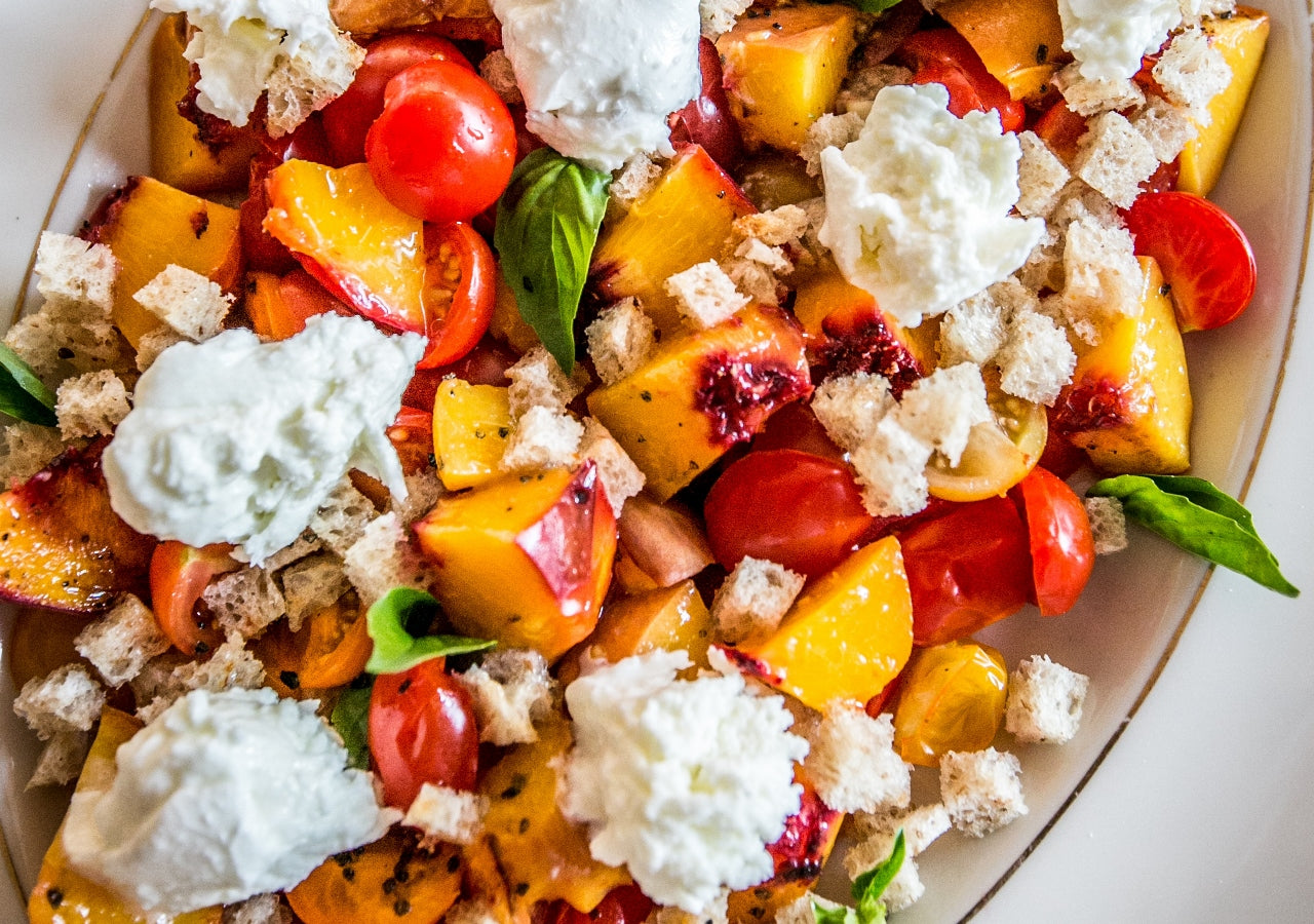 Peach, cherry tomato panzanella with burrata cheese